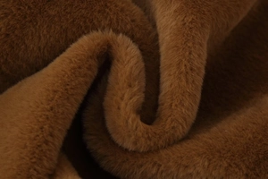 Close-up of soft brown faux fur fabric showing thick plush texture and luxury sheen