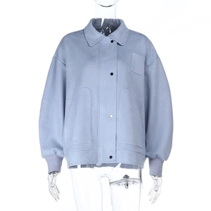 Detail of light blue casual polo jacket with metallic buttons and a side chest pocket