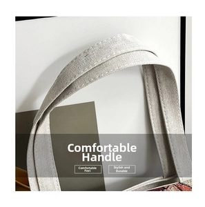 Detailed close-up of woven canvas bag handle showing durable stitching and fabric texture