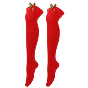 Detail of red Christmas over-the-knee socks featuring festive green and red bow accents