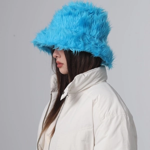 Detail view of plush blue faux fur bucket hat material and soft texture on female model