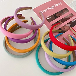 Stack of colorful thick padded headbands in matte fabric with soft sponge filling