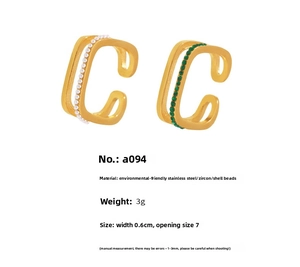 Detailed macro view of gold plated stainless steel ring with green zircon and shell pearl