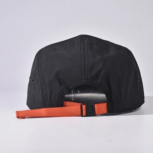 Detail of 5-panel outdoor cap with bright orange adjustable strap and black buckle closure