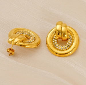 Macro detail of gold-plated stud earrings with two rows of sparkling pave-set crystals