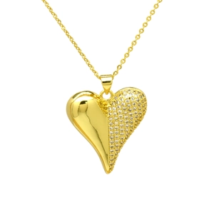 Detail of gold heart pendant necklace featuring half polished surface and white zircon pavé