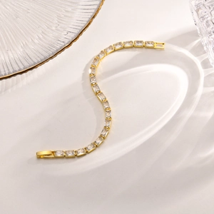 Detailed view of rectangle cut zircons in gold setting with elegant claw prongs