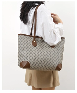 Brown leather trim tote bag shown on model shoulder for large capacity visual reference