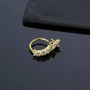 Elegant gold nose ring with cubic zirconia stones and a butterfly charm on black stone