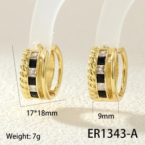 Detailed macro view of gold-plated hoop earrings with black and clear cubic zirconia