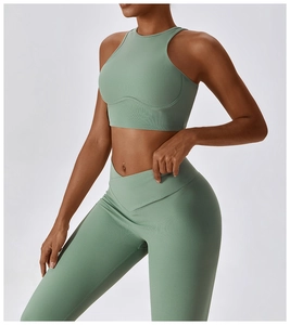 Detail of sage green ribbed knit yoga set with halter neck top and V-waist leggings