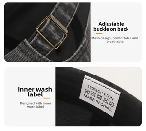 Detailed macro view of the metal adjustable buckle and cotton care label on a black cap