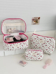 Three-piece set of quilted floral toiletry bags with mesh pockets and zipper closure