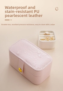 Macro shot of waterproof pink PU leather jewelry box with a secure gold metal button closure