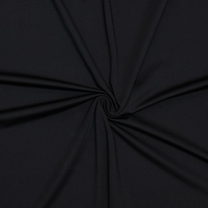 Detailed macro view of black fabric texture with dynamic swirl pleats for women's dress