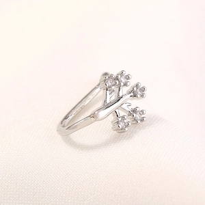 Detailed view of silver tree branch nose stud featuring sparkling round cubic zirconia