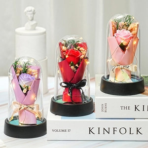Preserved roses in glass domes with LED lights on Kinfolk books, romantic gift set