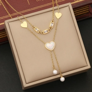 Double-layered gold stainless steel necklace with heart pendant, crystals and pearl tassels