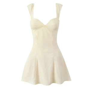 Detail of a beige slim fit off-shoulder mini dress with cross back straps and flared hem