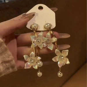 Elegant gold flower tassel earrings with shimmering petals and white hanging pearls