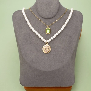 Gold chain with green rectangle gem and white pearl necklace with pink stone pendant
