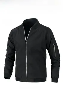 Detail of black bomber jacket featuring MA-1 style sleeve zipper pocket and ribbed cuffs