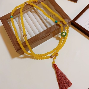 New Chinese style yellow amber-like bead necklace with green pendant and red silk tassel