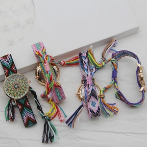 Detail view of four Bohemian woven fabric wristwatches with colorful tassel straps