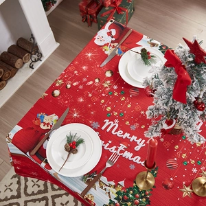Festive red Christmas tablecloth with Santa and snowflakes in a cozy holiday home setting