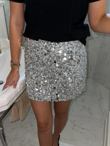 Close-up of silver sequin mini skirt showing reflective texture and elegant fit on a model
