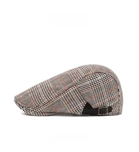 Close-up of classic plaid newsboy cap featuring a metal buckle and adjustable side strap