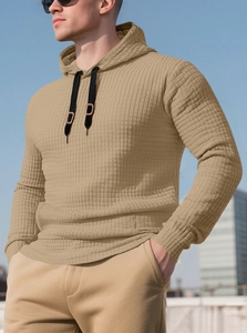 Detail of khaki waffle knit texture and black drawstring on men's pullover hoodie