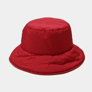 Close-up of red quilted winter bucket hat with wide brim and insulated down fabric
