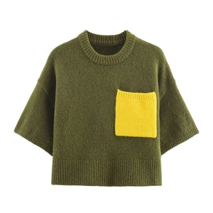 Detail of army green knit shirt featuring a bright yellow contrast chest pocket