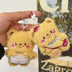 Detailed view of yellow and brown curly plush bear keychains with plastic hooks