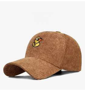 Detailed close-up of yellow duck embroidery on brown corduroy baseball cap texture