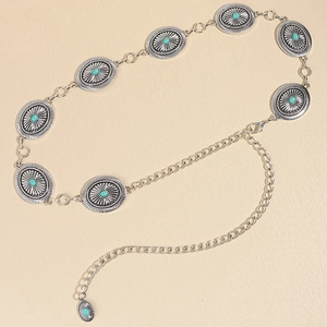 Detail view of retro Bohemian metal waist chain with turquoise stones and solar carvings