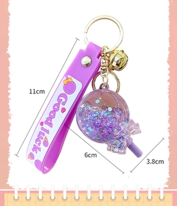 Detailed size view of the luminous purple lollipop keychain with dimensions and silver bell