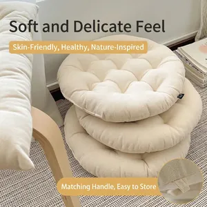 Thick beige quilted round tatami floor cushion with handle and soft cotton linen texture