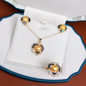 Detailed view of camellia jewelry set with gold pearls and colorful abalone shell inlays