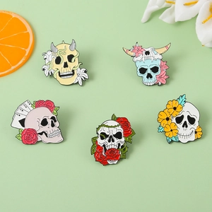 Five-piece colorful skull enamel pin set with floral and poker designs on green background