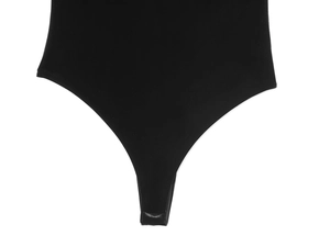 Detail of snap-button closure on black velvet bodysuit with high-cut design