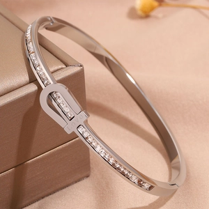 Macro shot of silver titanium steel bangle with LOVE engraving and cubic zirconia stones