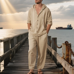 Detail of loose beige linen-cotton beach set with hooded shirt and wide-leg drawstring pants