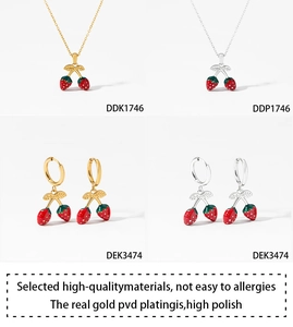 Vue détaillée du coffret bijoux fraise avec pendentifs en émail rouge en versions or et argent