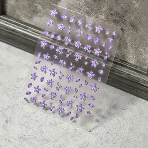 3D embossed purple floral nail stickers with falling petal designs on clear film