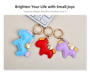 Detailed view of leather horse keychains in blue, red, and purple with golden hardware