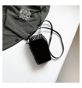 Detail of the spider web pattern on the black coffin-shaped PU leather crossbody bag