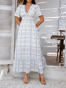 Close-up of white V-neck dress with blue bohemian print and ruffled short sleeves