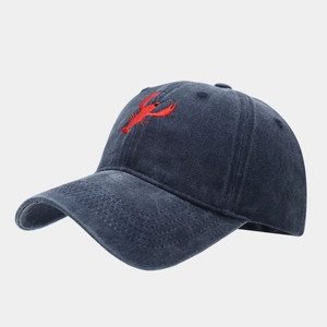 Detailed embroidery of a red lobster on a navy blue washed vintage cotton baseball cap